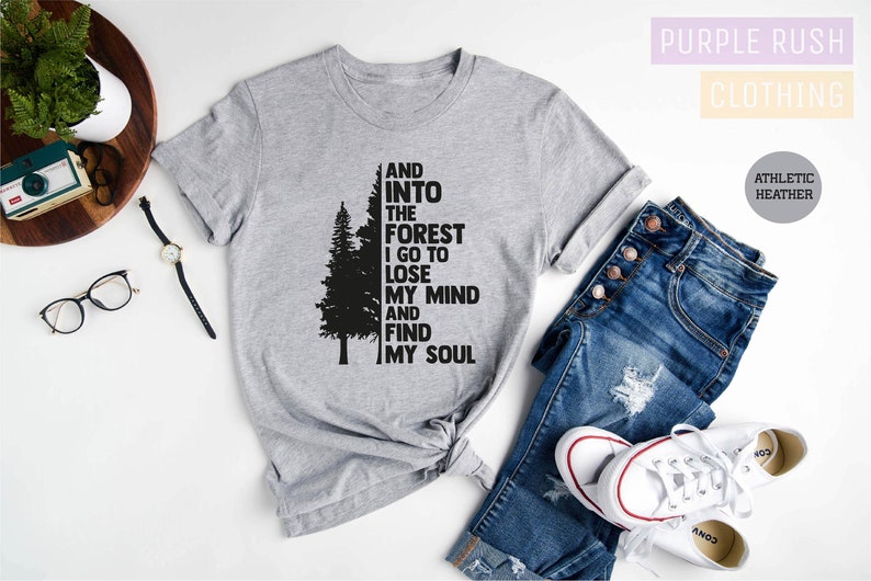 May include: Gray t-shirt with a black silhouette of a tree and the text "AND INTO THE FOREST I GO TO LOSE MY MIND AND FIND MY SOUL".