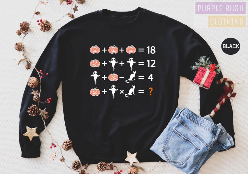 a black sweater with the numbers for halloween on it