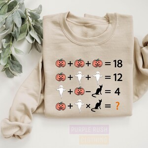 a t - shirt with a pumpkin and ghost addition on it