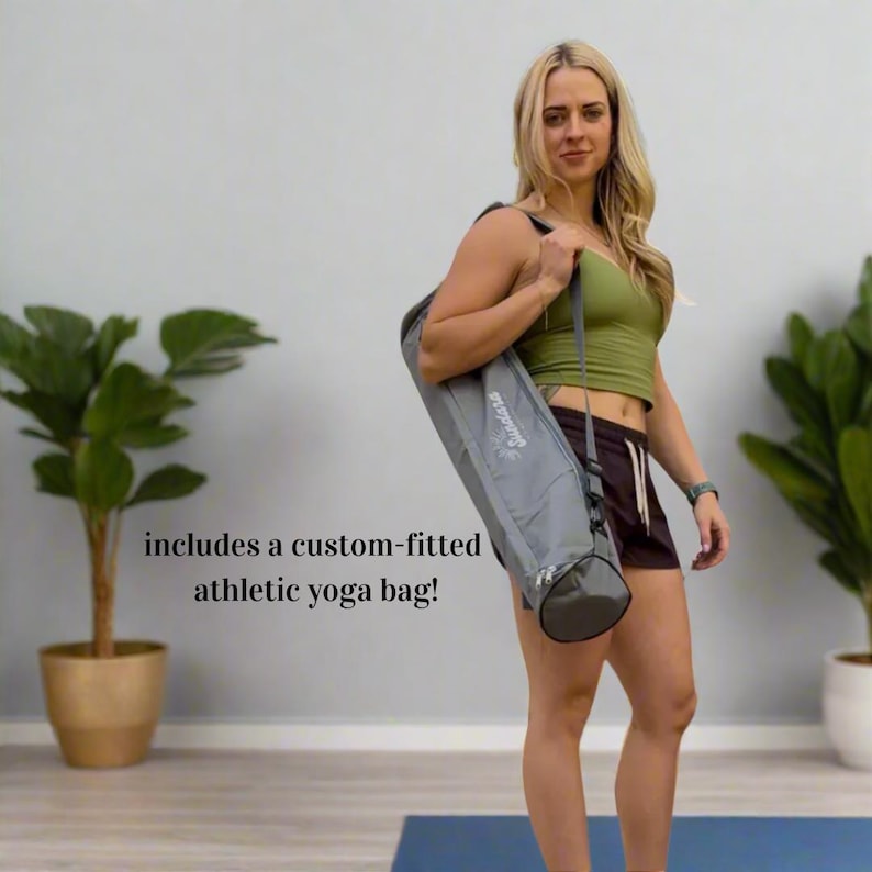 May include: A gray athletic yoga bag with a shoulder strap is carried by a person. The bag has a cylindrical shape with a dark gray bottom and a light gray body. The text on the bag reads "Prosource". The image also includes the text "includes a custom-fitted athletic yoga bag!"