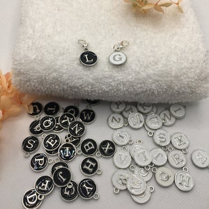 Black or white letter charms, monochromatic silver colored pendant with matching carabiner charm