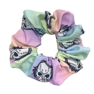 May include: A pastel rainbow scrunchie with a repeating pattern of hockey masks.