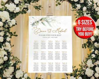 May include: A white wedding seating chart with gold lettering and greenery accents. The chart is displayed on an easel in front of a white floral arch. The text on the chart reads "Donna & Michael Please Find Your Seat June 1, 2023 - New York"