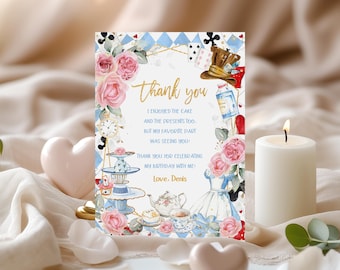 May include: A watercolor thank you card with a whimsical Alice in Wonderland theme. The card features a tea party scene with a teapot, teacups, and a Mad Hatter hat. The text on the card reads "Thank you. I enjoyed the cake and the presents too. But my favorite part was seeing you! Thank you for celebrating my birthday with me! Love. Denis."