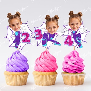 May include: Three cupcake toppers featuring a girl's face superimposed on a cartoon spider-girl character. The toppers are decorated with a spider web design and the numbers 2, 3, and 4.