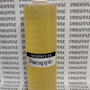 May include: A tall, yellow bottle of pineapple fragrance oil with a white cap. The label reads "FRAGRANCE OIL Pineapple". The background features a repeating pattern of the word "PINEAPPLE".