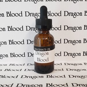 May include: A small amber glass bottle with a black dropper top. The bottle is labeled "FRAGRANCE OIL" and "Dragon Blood".
