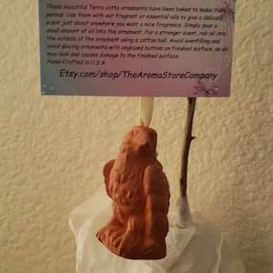 May include: Terracotta bird ornament with a string for hanging. The ornament is porous and can be used with essential oils to add fragrance to a room. The card attached to the ornament includes directions for use and the Etsy shop name: Etsy.com/shop/TheAromaStoreCompany.