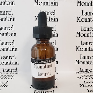 May include: A brown glass bottle with a dropper top, labeled "FRAGRANCE OIL Mountain Laurel".