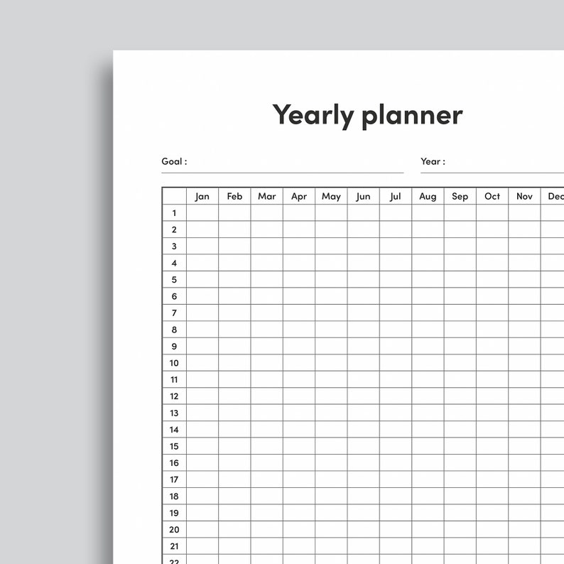 May include: A black and white yearly planner with a grid layout. The planner has spaces for each month of the year, from January to December. The planner also has a space for a goal and a year.