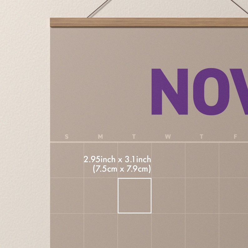 May include: A beige wall calendar with the month of November in large purple letters. The calendar has a wooden hanger and includes the text "2.95inch x 3.1 inch (7.5cm x 7.9cm)".