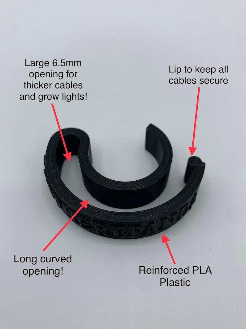 May include: Black cable organizer made of reinforced PLA plastic. It has a large 6.5 mm opening for thicker cables and a long curved opening. The lip helps keep cables secure.