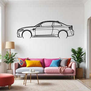 May include: A black and white line drawing of a car on a white wall. The car is a coupe with a sleek design. The drawing is a simple outline of the car, with no details or shading.