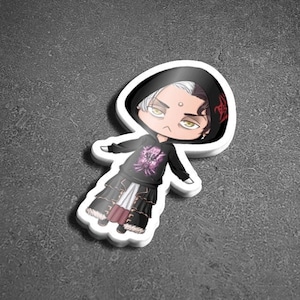 May include: A sticker featuring a cartoon character with white hair, wearing a black hooded sweatshirt with a pink and black design, and black and white trousers. The character has a red and black design on the back of their hood.
