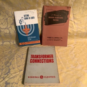 May include: Three vintage technical manuals. The top left book is titled "Getting Down-to-Earth" with a blue and orange graphic. The top right book is "A Manual on Ground Resistance Testing." The bottom book is "Transformer Connections."