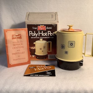 May include: Vintage Regal Poly Hot Pot beverage warmer/server. The cream-colored electric pot has a brown base and handle, with a matching lid. The pot features a geometric design. The original box and instruction manual are included.