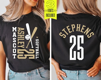 May include: A black t-shirt with a gold softball design on the front. The design includes two crossed bats, a baseball, and the text "ASHLEY 25" and "MASCOT" vertically stacked. The back of the shirt has the text "STEPHENS 25" in gold.