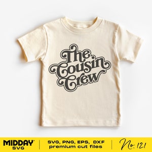 May include: A beige t-shirt with a black graphic that says "The Cousin Crew" in a retro font.