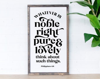 May include: A white sign with a black wooden frame and the text "WHATEVER IS noble right pure & lovely think about such things. Philippians 4:8" in a decorative font.