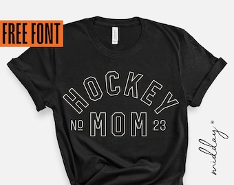 May include: Black t-shirt with white text that reads "Hockey Mom" with the numbers "No. 23" on either side of the word "Mom".