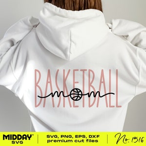 May include: A white hoodie with a pink design that says "Basketball Mom" with a basketball graphic in the middle of the word "mom".