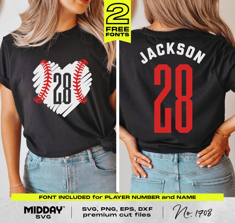 May include: A black t-shirt with a white heart-shaped baseball design and the number 28 inside. The back of the shirt has the name "JACKSON" and the number 28 in red. The shirt is being modeled by a person wearing blue jeans.