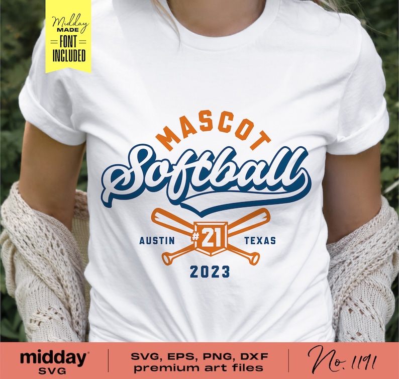 May include: A white t-shirt with a blue and orange softball design. The design includes the text "MASCOT Softball", "AUSTIN", "#21", "TEXAS", and "2023".