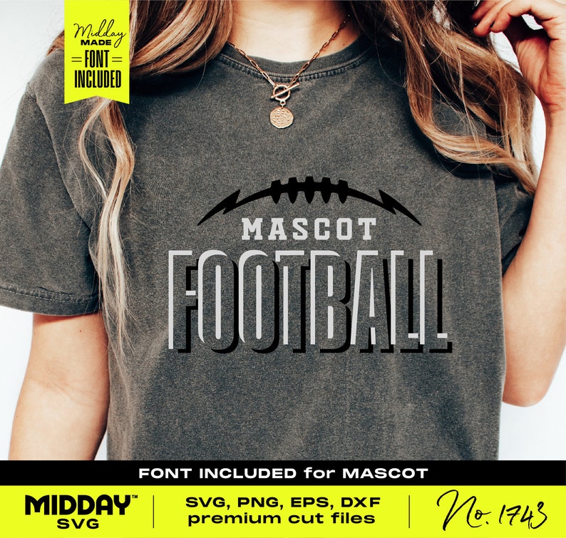 May include: A gray t-shirt with a black and white graphic design that says "MASCOT FOOTBALL" with a football graphic above the text. The text "FONT INCLUDED for MASCOT" is below the graphic. The text "MIDDAY SVG" is in the bottom left corner and the text "No. 1743" is in the bottom right corner.