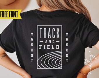 May include: Black t-shirt with a white graphic that reads "TRACK AND FIELD" inside a rectangular frame. The word "MASCOT" is printed vertically on both sides of the frame. The shirt also has the text "FREE FONT" in a yellow banner.