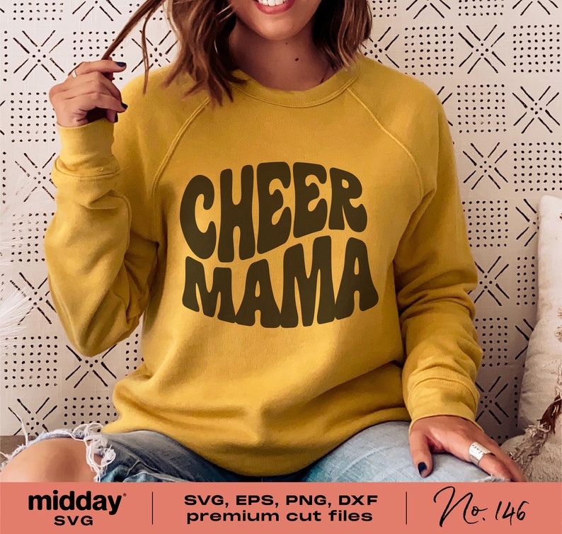 May include: A yellow sweatshirt with the text "CHEER MAMA" in brown, retro-style lettering.
