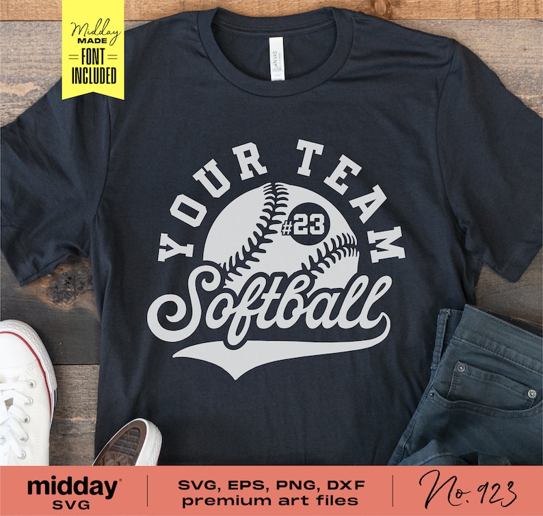 May include: A black t-shirt with a white graphic design of a softball with the text "YOUR TEAM Softball" and the number "#23" on the ball.