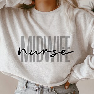 May include: A gray sweatshirt with the text "MIDWIFE nurse" printed in black on the front.