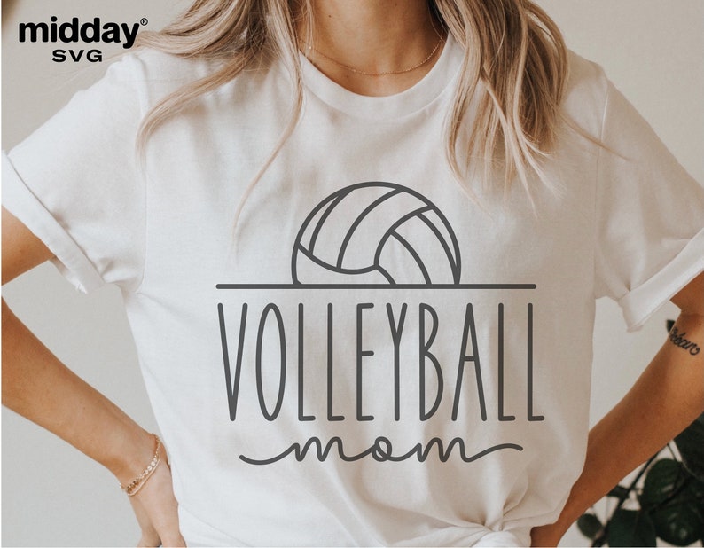 May include: White t-shirt with a black outline of a volleyball and the text "VOLLEYBALL mom" in a handwritten font.