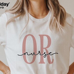 May include: White t-shirt with the letters "OR" in pink and the word "nurse" written in cursive underneath.