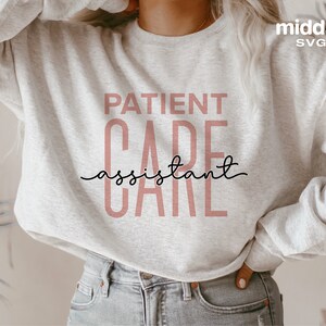 May include: A gray sweatshirt with the text "PATIENT CARE assistant" in pink lettering.