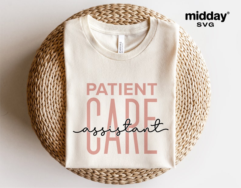 May include: A beige t-shirt with the text "PATIENT CARE assistant" in pink and black lettering.
