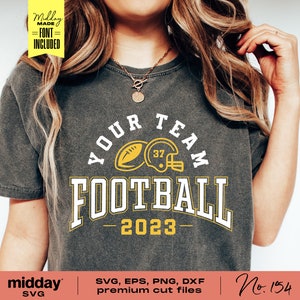 May include: A gray t-shirt with a yellow and white graphic design that says "Your Team Football - 2023". The graphic includes a football and a football helmet.