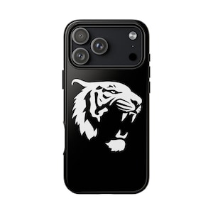 May include: A black smartphone case featuring a high-contrast white graphic of a roaring tiger head in profile. The design is centered on the back of the case, which also includes a cutout for the triple-lens camera system and flash.