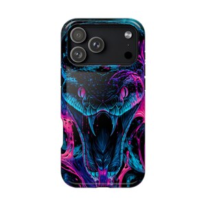 May include: A smartphone case featuring a high-contrast graphic of a snake with its mouth open, displaying sharp fangs. The design uses vibrant neon blue and hot pink colours against a dark background, creating a striking, fluid, and layered effect.