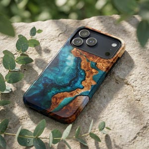 May include: A smartphone case with a unique design. The case features a combination of teal and brown tones, creating a marbled effect. The case has a glossy finish and a black camera module with three lenses.