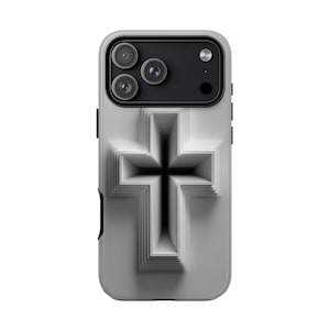 May include: A light grey phone case with a three-dimensional cross design. The case has a matte finish and a raised cross creating a shadow effect. The phone's camera lenses are visible at the top.