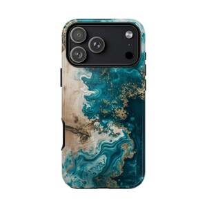 May include: A smartphone case with a swirling teal, gold, and beige abstract design. The case has a glossy finish and a black camera module with three lenses. The design resembles a marble or agate pattern.