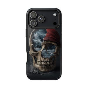 May include: Black phone case featuring a skull design with a red bandana. The skull's eye sockets and nasal cavity reveal a stormy ocean scene. The case has a glossy finish and a triple-lens camera cutout.