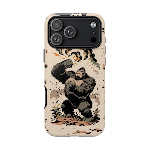 May include: A phone case featuring a cartoon illustration of a gorilla in a dynamic pose, with a backdrop of an explosion. The design incorporates shades of brown, black, and tan, creating a bold and eye-catching aesthetic. The case is designed to fit a smartphone.