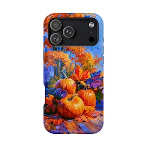 May include: A rectangular phone case featuring a vibrant, painterly autumn scene with three orange pumpkins nestled among colorful fall foliage in shades of red, yellow, and orange, set against a backdrop of trees under a bright blue sky.