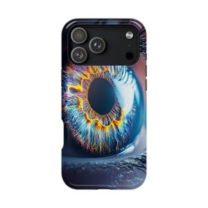 May include: A smartphone case featuring a high-resolution graphic of a human eye. The iris displays vibrant shades of blue, orange, and yellow with intricate fiber details. The pupil is a solid black circle, surrounded by eyelashes at the bottom.