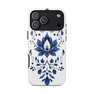 May include: White phone case with a blue floral design. The case features a detailed blue lotus flower and foliage pattern. The phone case has a black camera module with three lenses.