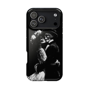 May include: A black smartphone case featuring a high-contrast white graphic of two skeletons in formal attire embracing. The figure on the left wears a wide-brimmed hat with floral details, while the figure on the right wears a top hat and suit.