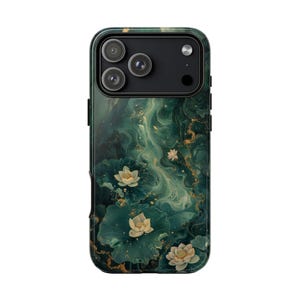 May include: A smartphone case with a green marble design featuring white lotus flowers and gold accents. The case has a glossy finish and a camera cutout for a triple-lens system.