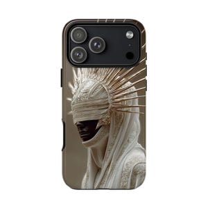 May include: A phone case featuring a detailed illustration of a person wearing an elaborate white headdress with gold accents. The case has a dark brown border and a triple-lens camera cutout.